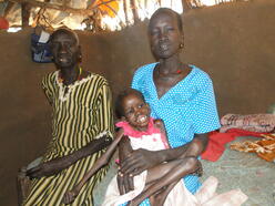 Nyathok Deng (left) with daughter, Amach, and grandchild, Anyieth. The little girl was emaciated when she was admitted to the IRC hospital in Kakuma refugee camp in Kenya.