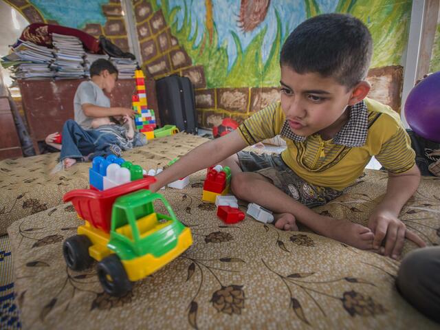 A disabled Syrian boy plays at an IRC class for children with special needs at the Karameh camp, Syria.