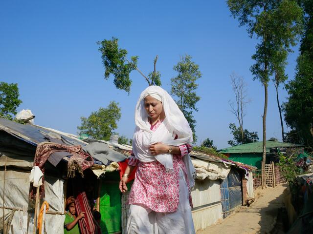 Razia walking through the camps near Cox's Bazar where close to one millions Rohingya people are living. 