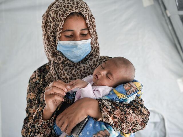 Woman holding a sleeping baby