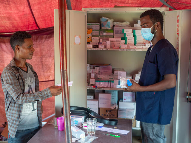 IRC staff at the health centre exchanging medicine