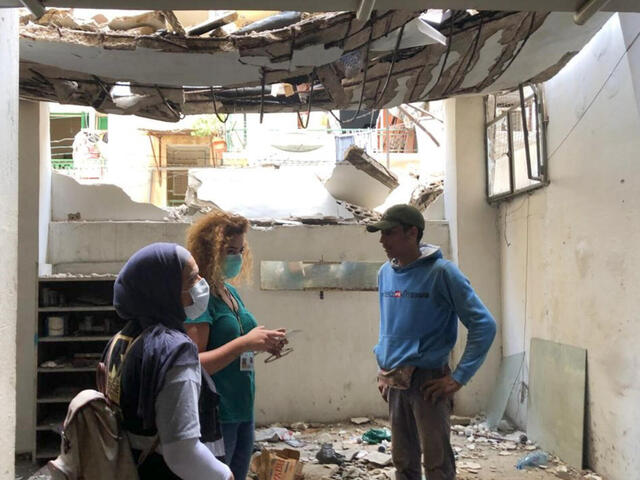 An IRC staff member interviews the employee of a car mechanic’s garage in a building damaged by the Beirut blast