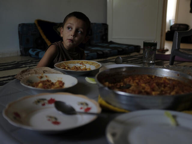 Boy eating a healthy dinner in Jordan