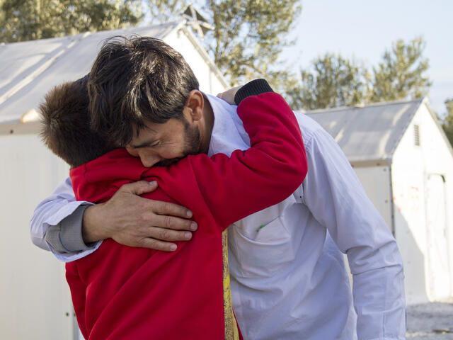 Afghan refugee father is reunited with his son.