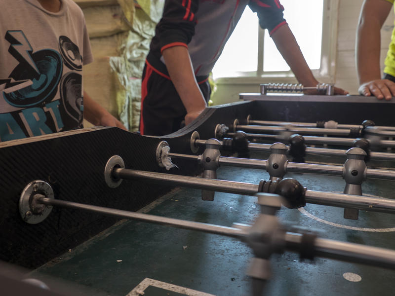 Unaccompanied children living in Azraq refugee camp spend the afternoon playing foosball with friends at a recreation room. Unaccompanied children living in Azraq refugee camp spend the afternoon playing foosball with friends at a recreation room.