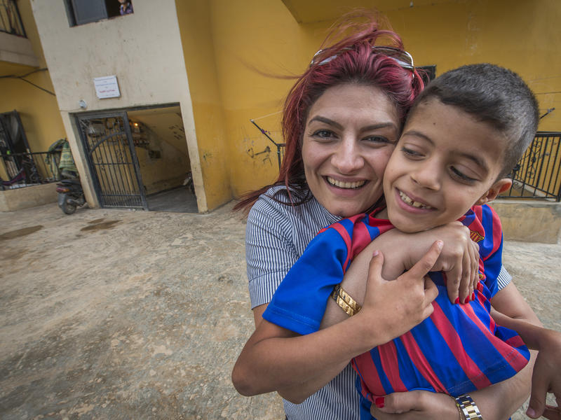 Roushan Khalaf with a refugee child in Bebnine, Lebanon Roushan Khalaf with a refugee child in Bebnine, Lebanon