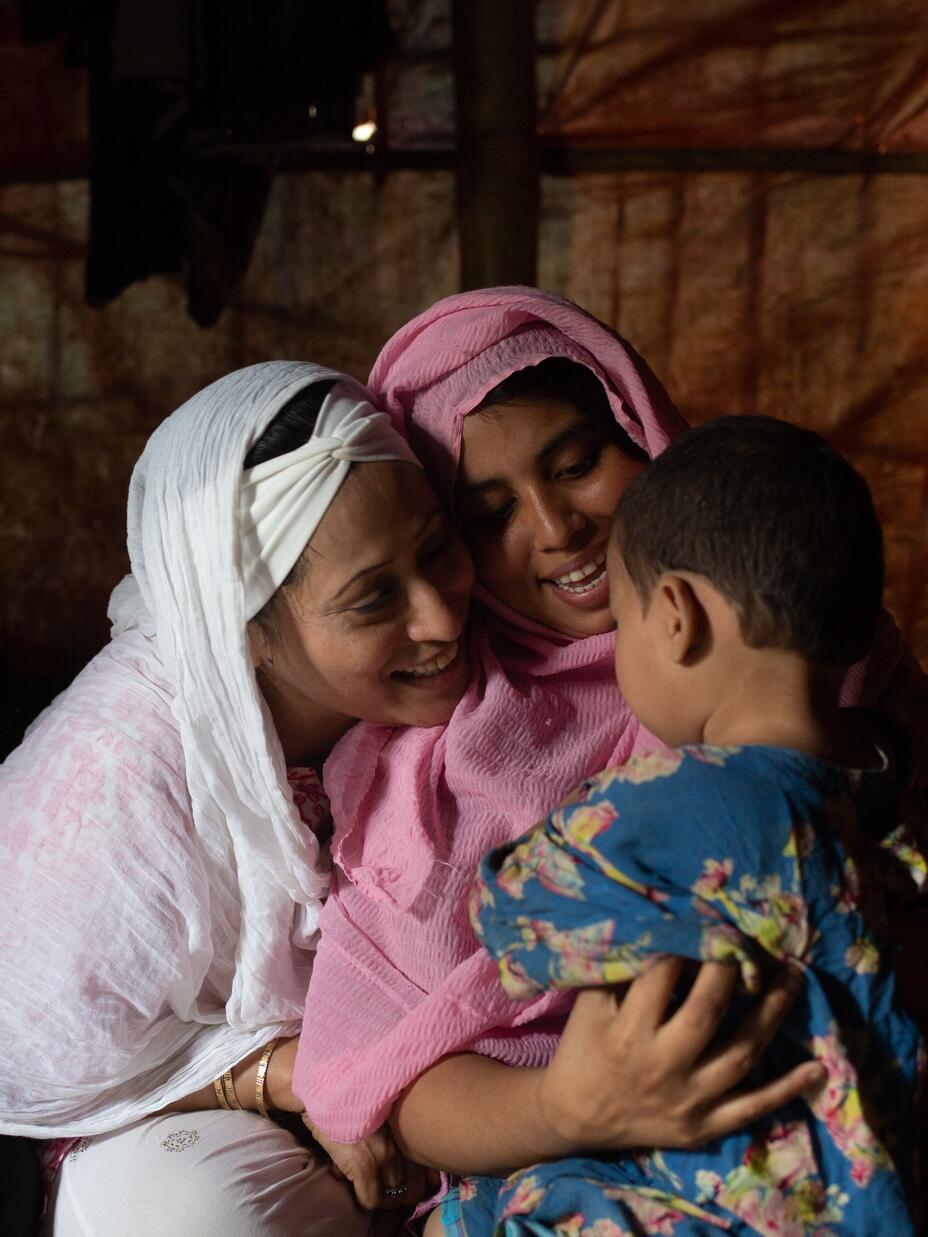 Razia counsels a child and mother in a camp near Cox's Bazar in Bangladesh