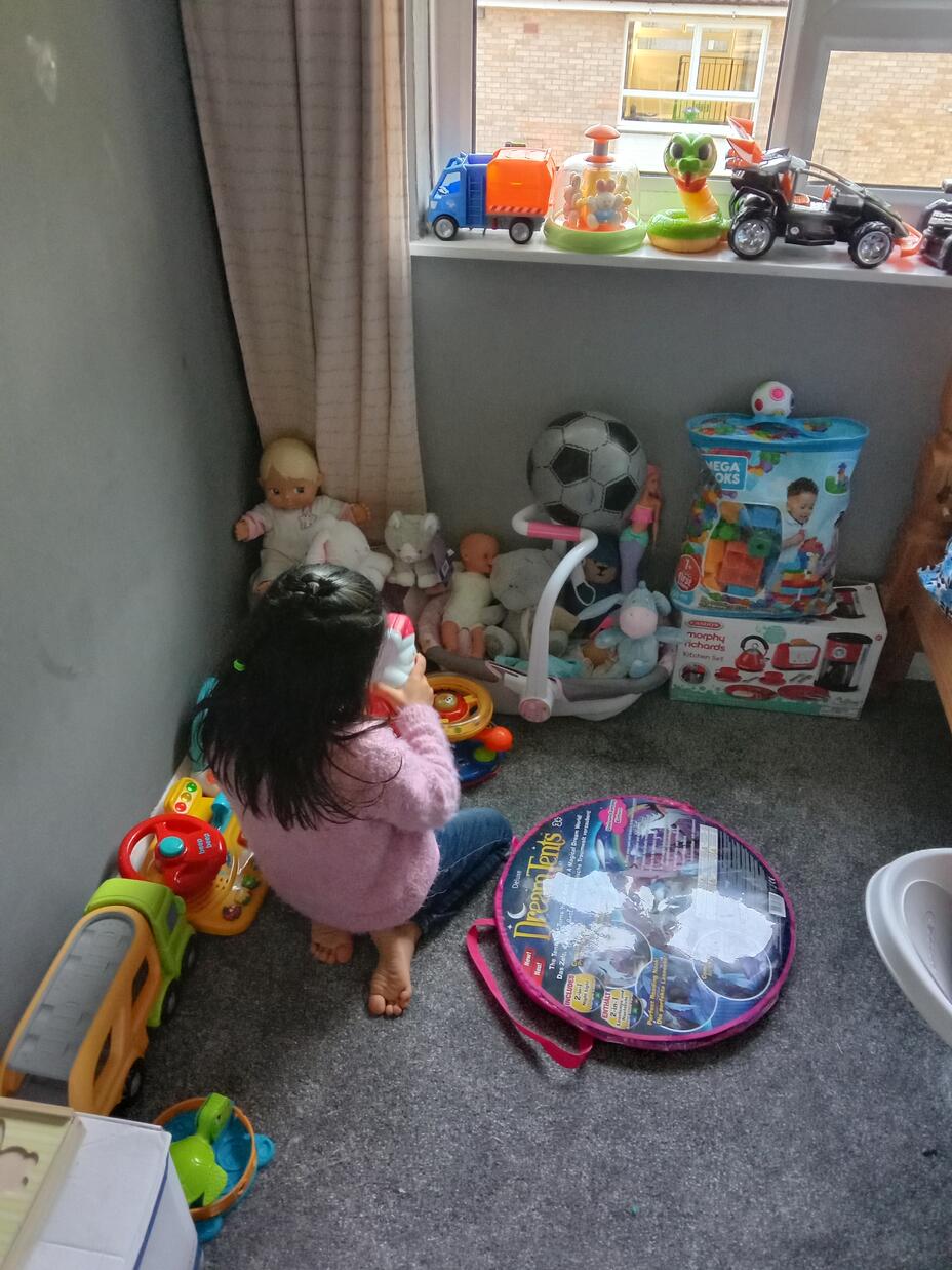 Sahib's daughter playing with her toys in our new home in South East England.