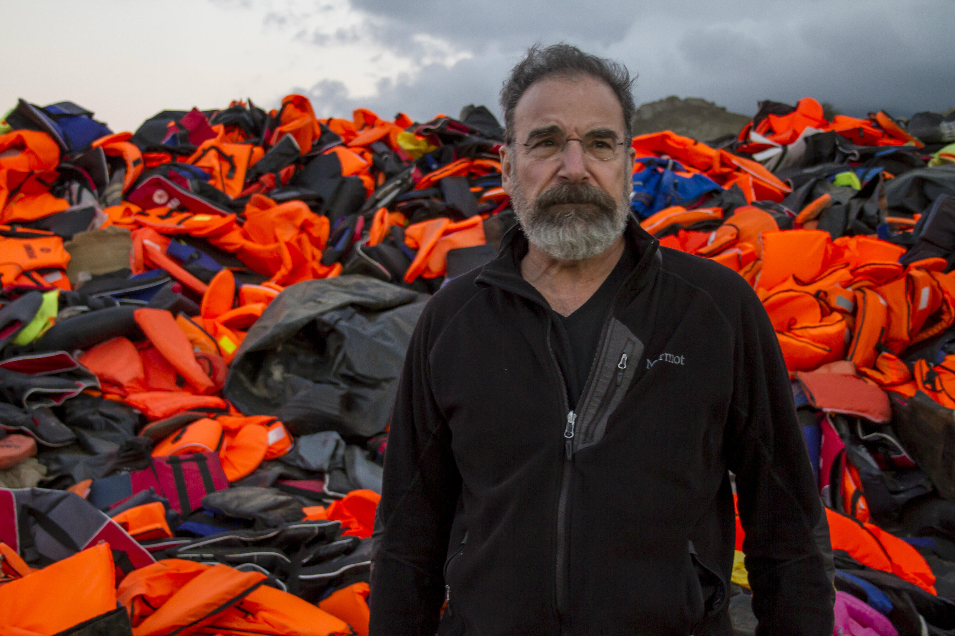 Mandy Patinkin with lifejackets used by refugees
