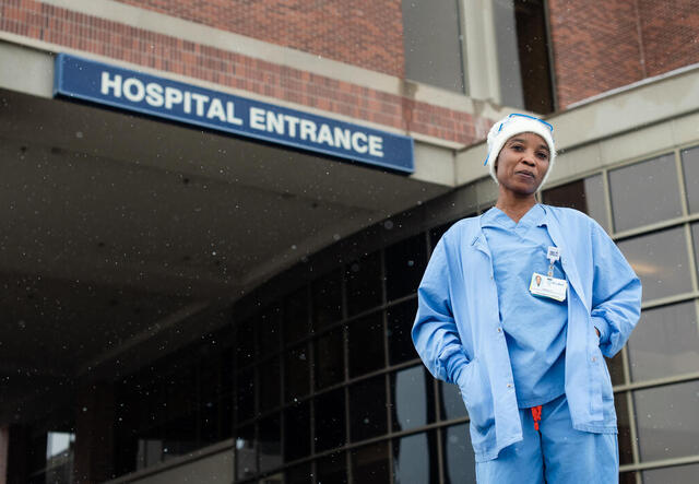 Nabila standing outside a hospital entrance