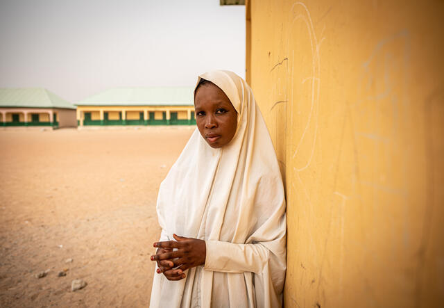 Amina stands outside the IRC's SAFE session in North-East Nigeria