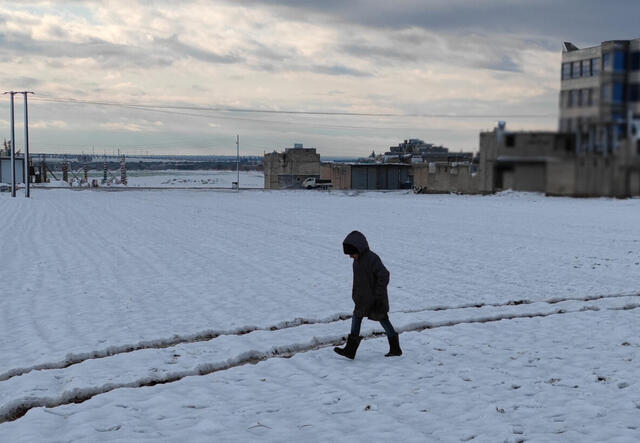 A child walking across an expanse of snow