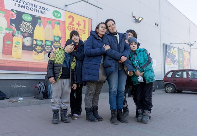 Two women, Marta and Oksana, standing with four children