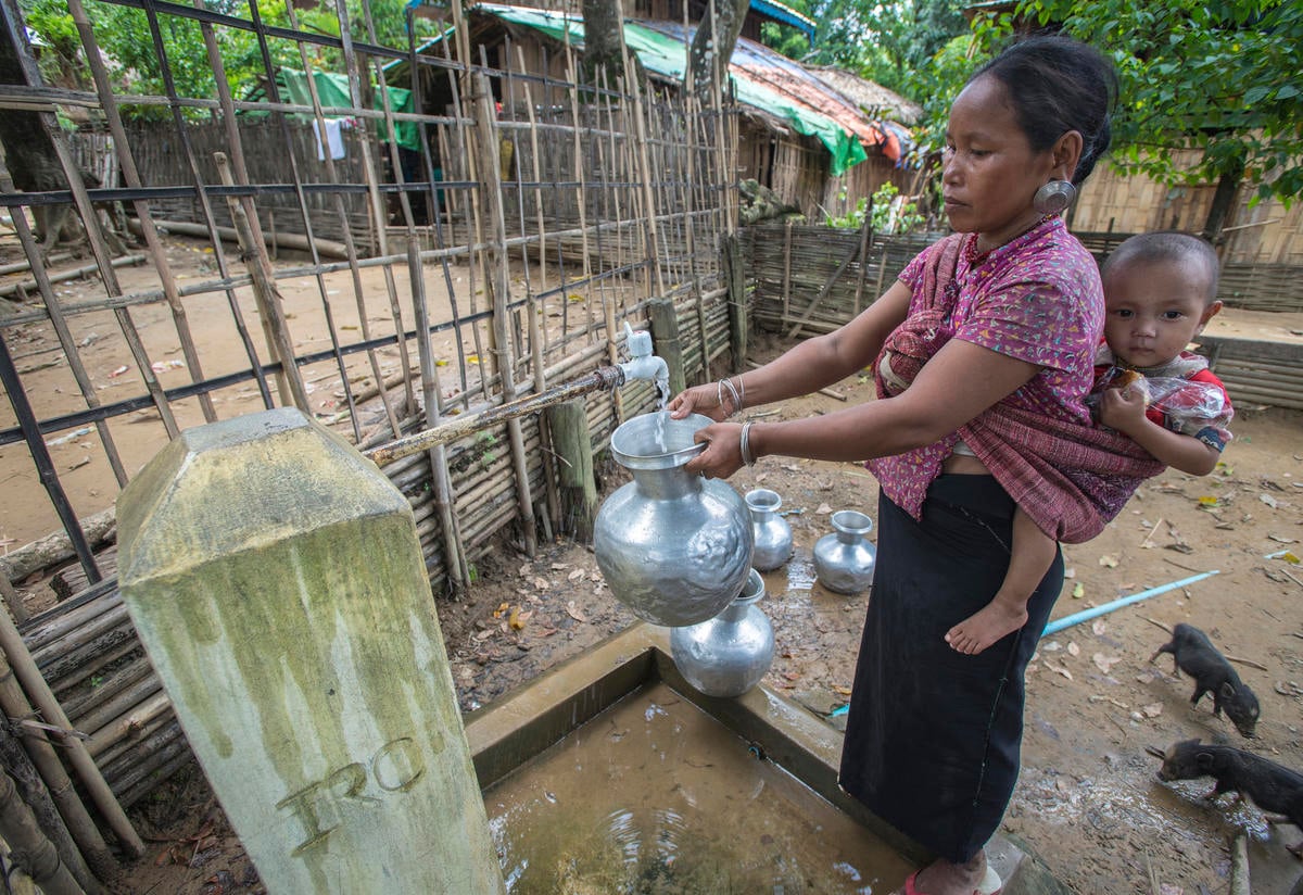 Woman in Myanmar collects water from IRC tap